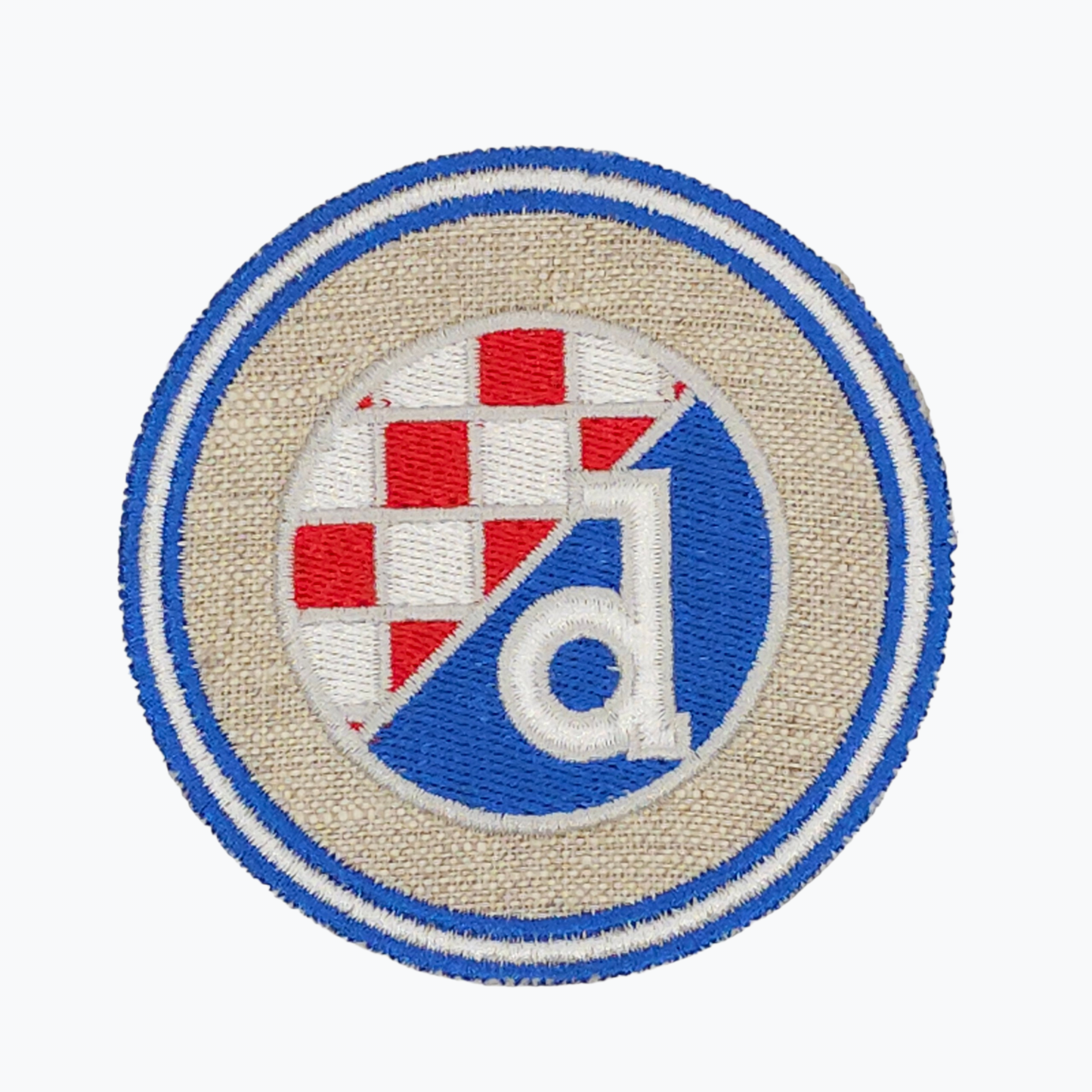 Dinamo Beige Clothes Patch. Embroidered patch with a circular design featuring a flag and a logo on a beige background.