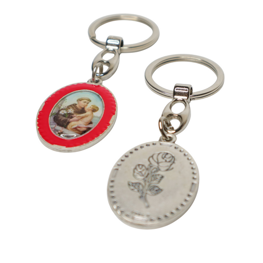 Keyring Saint Anthony of Padua – Double-Sided Religious Medal (Red Enamel) Two keychains, one with a red border and image of a person holding a child, the other with a silver rose design.