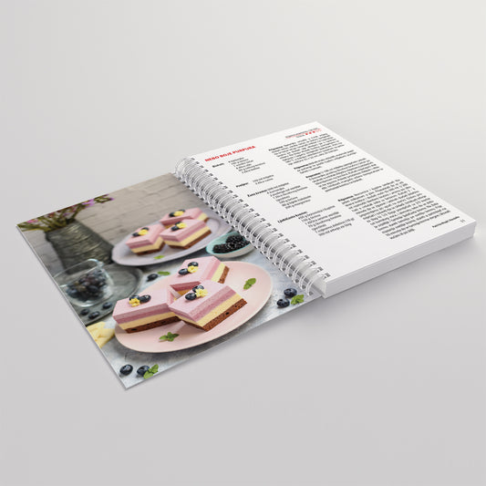 Moji Kremasti KOLAČI Open cookbook showing a recipe for heart-shaped desserts on a gray background