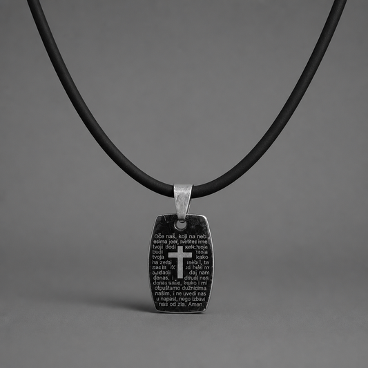 Oče Naš Necklace Black pendant with cross and text on a black cord against a gray background