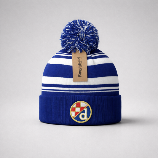 Beanie Dinamo Zagreb Pom Pom in Blue Blue and white striped beanie with pom-pom and brand tag on a light gray background