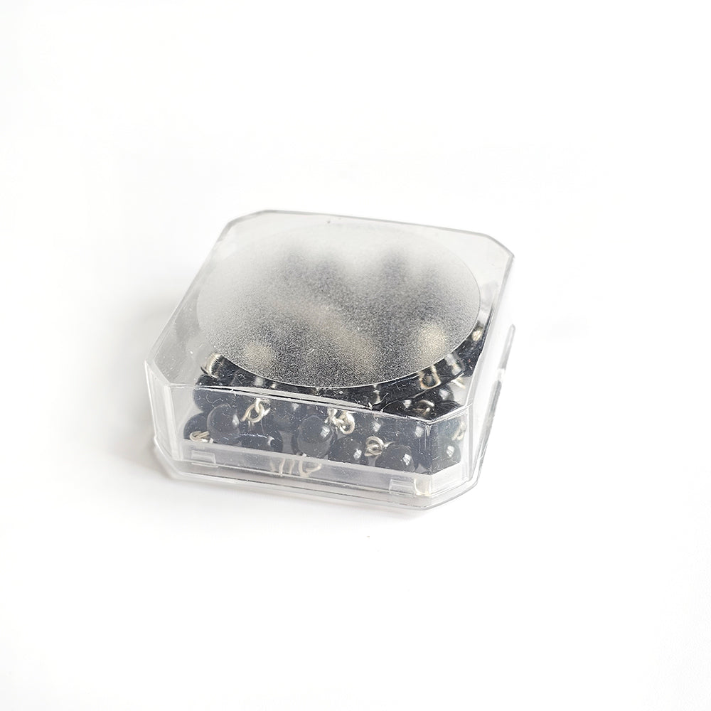 Black Catholic Rosary – Silver Crucifix & Marian Medal Clear plastic container with a black object inside on a white background