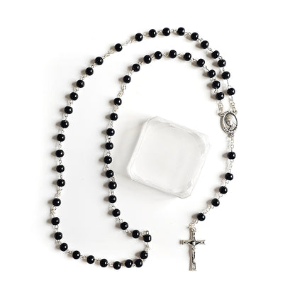Black Catholic Rosary – Silver Crucifix & Marian Medal Black rosary with a silver cross on a white background