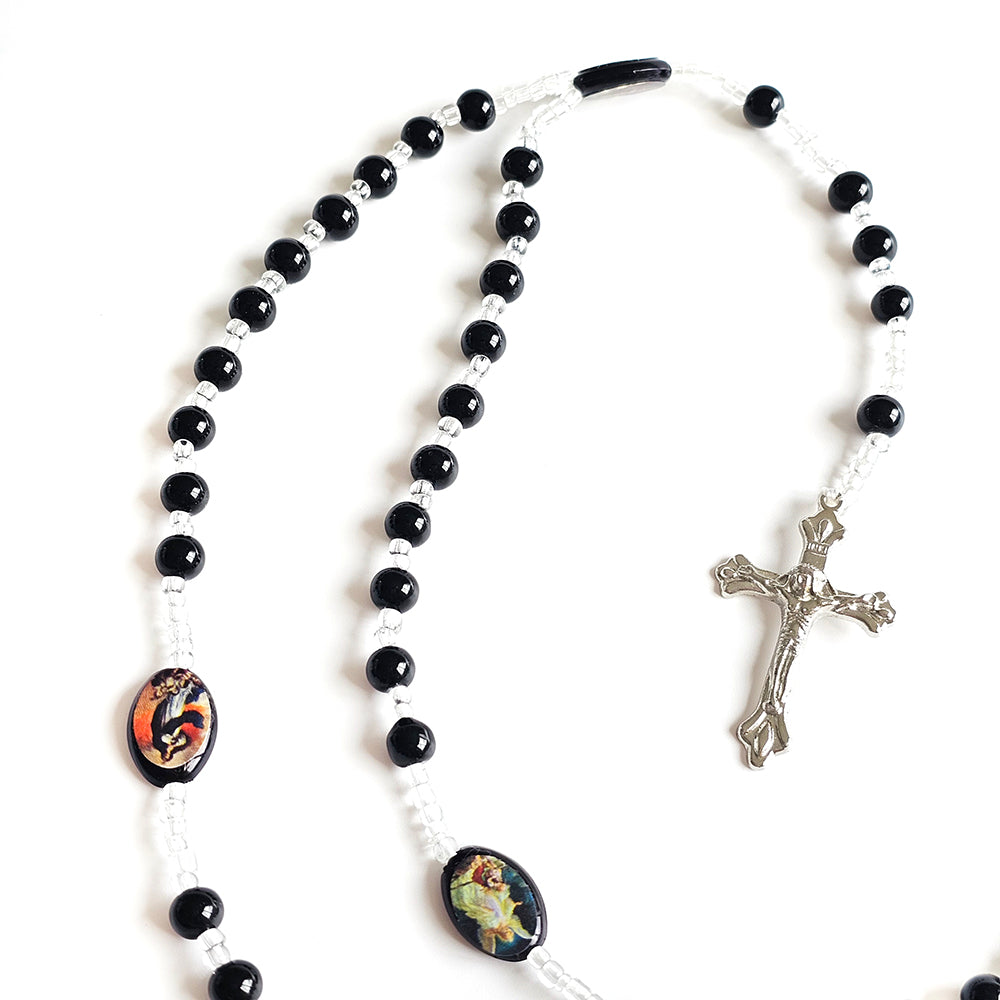 Black & White Catholic Rosary with Religious Medals – Silver Crucifix Black and white rosary with colorful oval beads and a silver crucifix on a white background