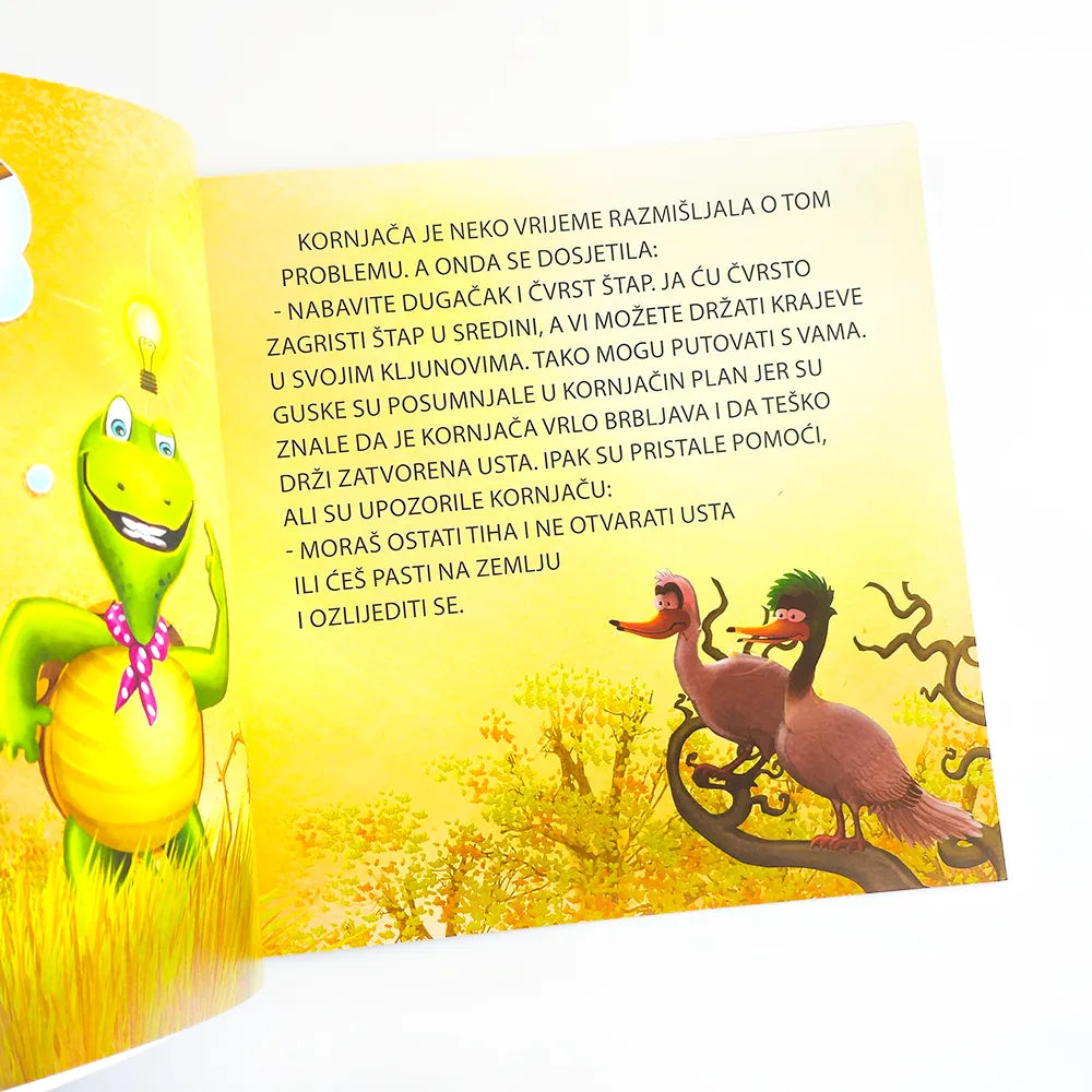 Brbljava Kornjača Open book with colorful illustrations and text on a yellow background