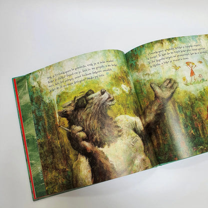 CRVENKAPICA (2020) Open book with illustrations of a wolf and a bear in a forest setting on a white background.