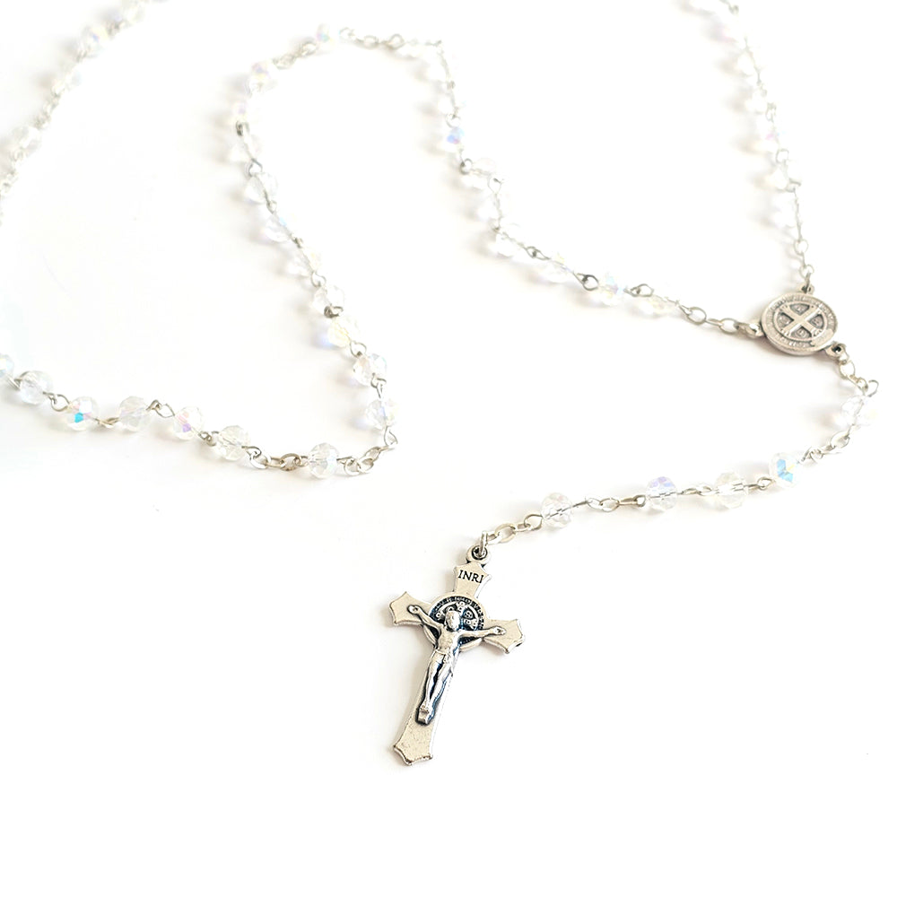 Clear Crystal Saint Benedict Rosary – Silver Crucifix & Medal Silver rosary with a cross pendant on a white background