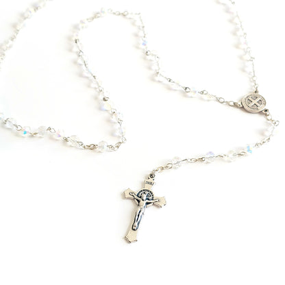Clear Crystal Saint Benedict Rosary – Silver Crucifix & Medal Silver rosary with a cross pendant on a white background