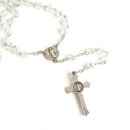 Clear Crystal Saint Benedict Rosary – Silver Crucifix & Medal Silver rosary with beads on a white background