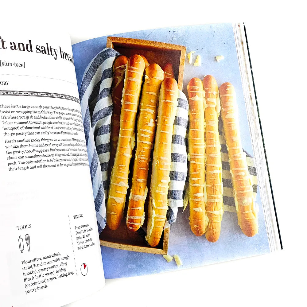 Croatian Savoury Baking: Cookbook in English Language Wooden tray with bread rolls on a magazine page