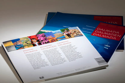 Dalmatia – Dalmatien – Dalmazia Brochures with travel images and text on a light surface