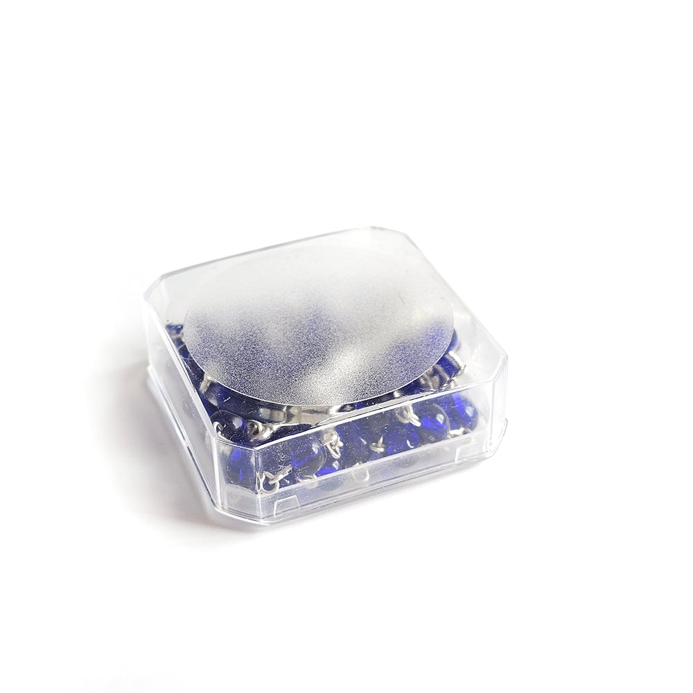 Dark Blue Catholic Rosary – Silver Crucifix & Marian Medal Clear plastic container with blue and silver contents on a white background
