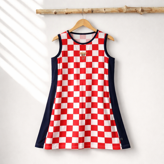 Dress Croatia Checks (shorter) Red and white checkered dress with navy sleeves on a hanger against a white background