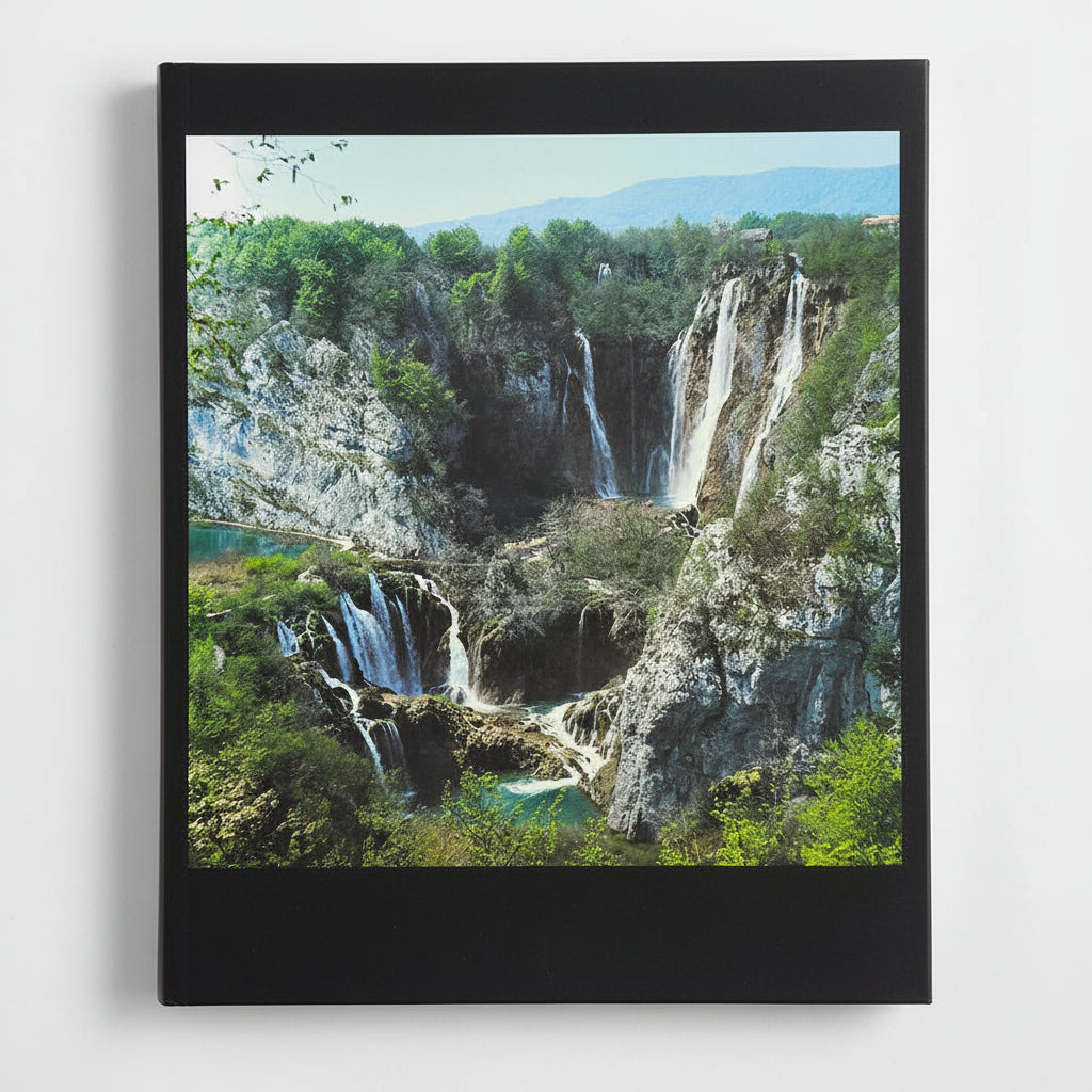 Hrvatska - Photographic Monograph Framed picture of a waterfall landscape with greenery and mountains.