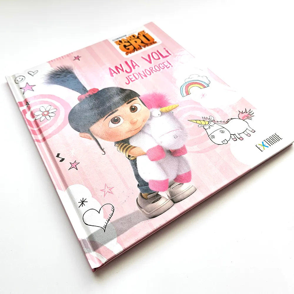 Kako je Gru Postao Dobar Anja Voli Jednoroge! Book cover with a cartoon character holding a unicorn on a pink background