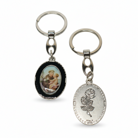 Keyring Saint Anthony of Padua – Double-Sided Religious Medal (Black Enamel) Two keychains with different designs on a white background