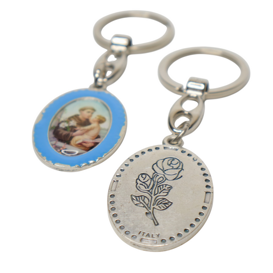 Keyring Saint Anthony of Padua – Double-Sided Religious Medal (Blue Enamel) Two silver keychains with religious designs on a white background