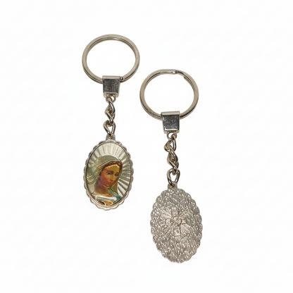 Keyring Virgin Mary with Engraved Cross (oval) Two keychains with religious-themed designs on a white background