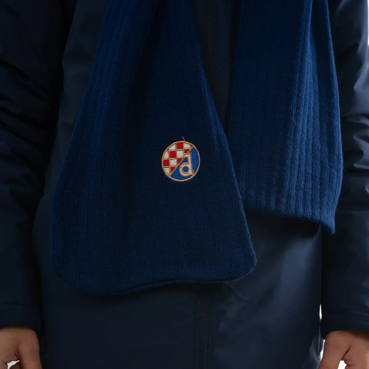 Kids Knitted Scarf and Beanie Dinamo Zagreb Blue sweater with a embroidered emblem on a dark background