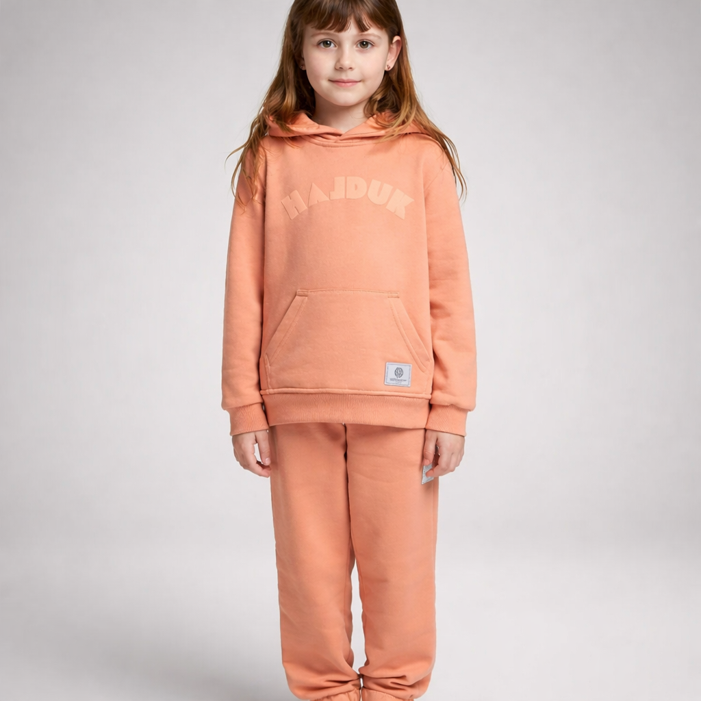 Child wearing a peach-colored hoodie and pants with 'MAJOR' branding on a gray background Kids Tracksuit Hajduk