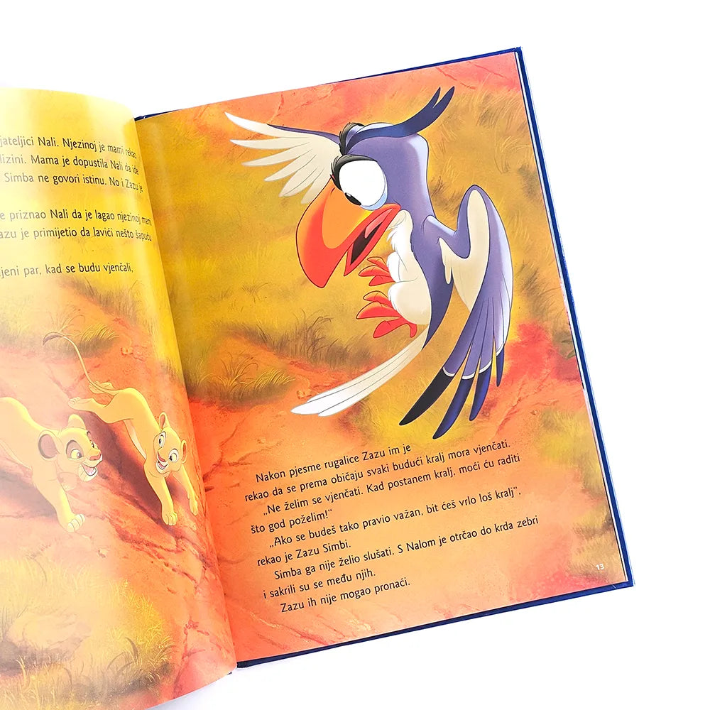 Kralj Lavova by Disney Open book with colorful illustration of a bird on a white background
