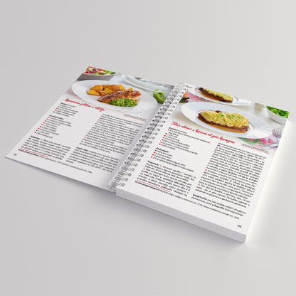 Kuhaj Slano, Kuhaj Fino! Open cookbook showing recipe pages with images of food on a light gray background