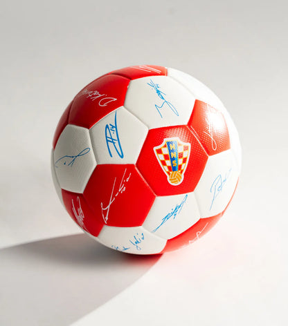 Mini Soccer Ball HNS with player signatures Red and white soccer ball with signatures on a light gray background