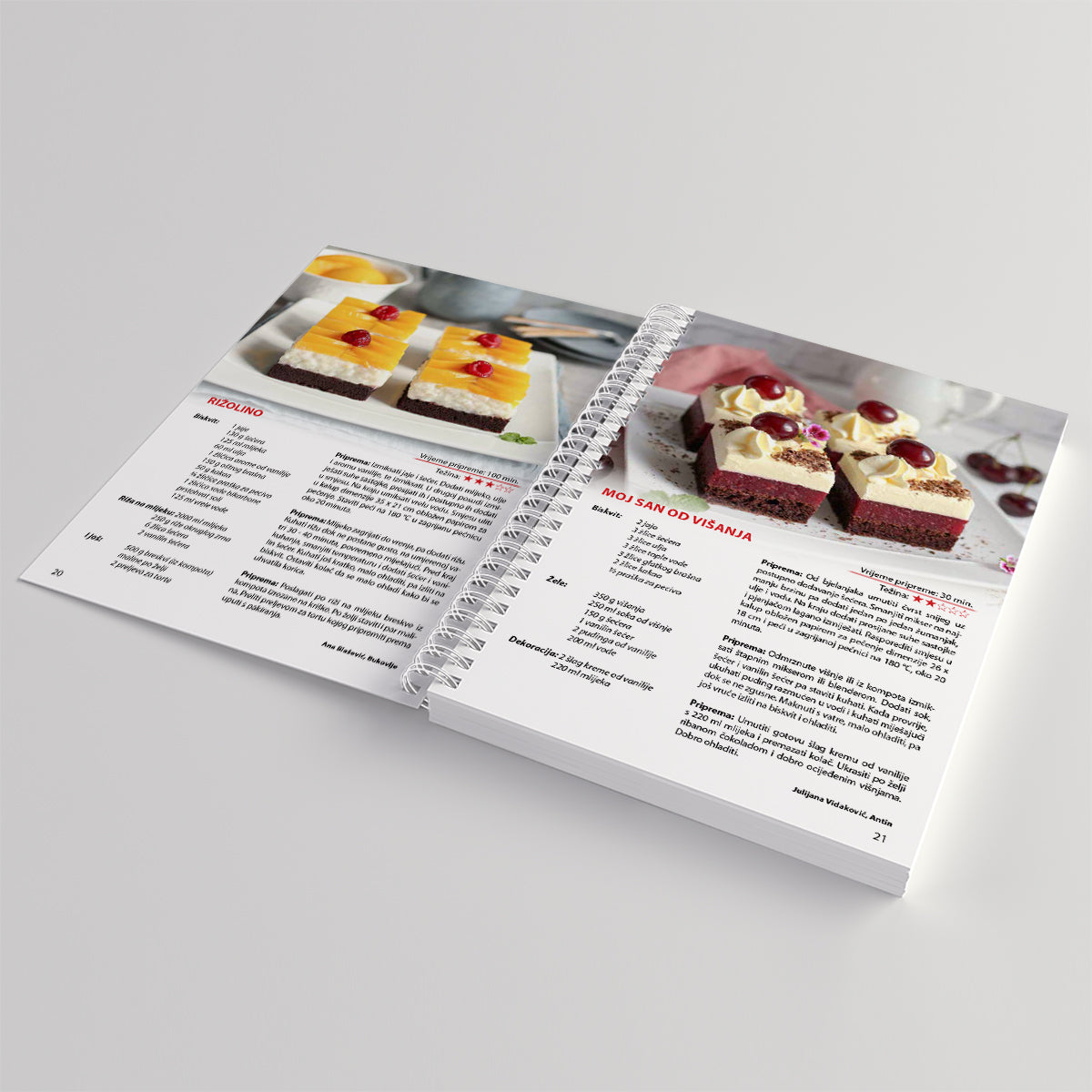 Moji Voćni Kolači Open cookbook showing pages with dessert recipes and images on a light gray background