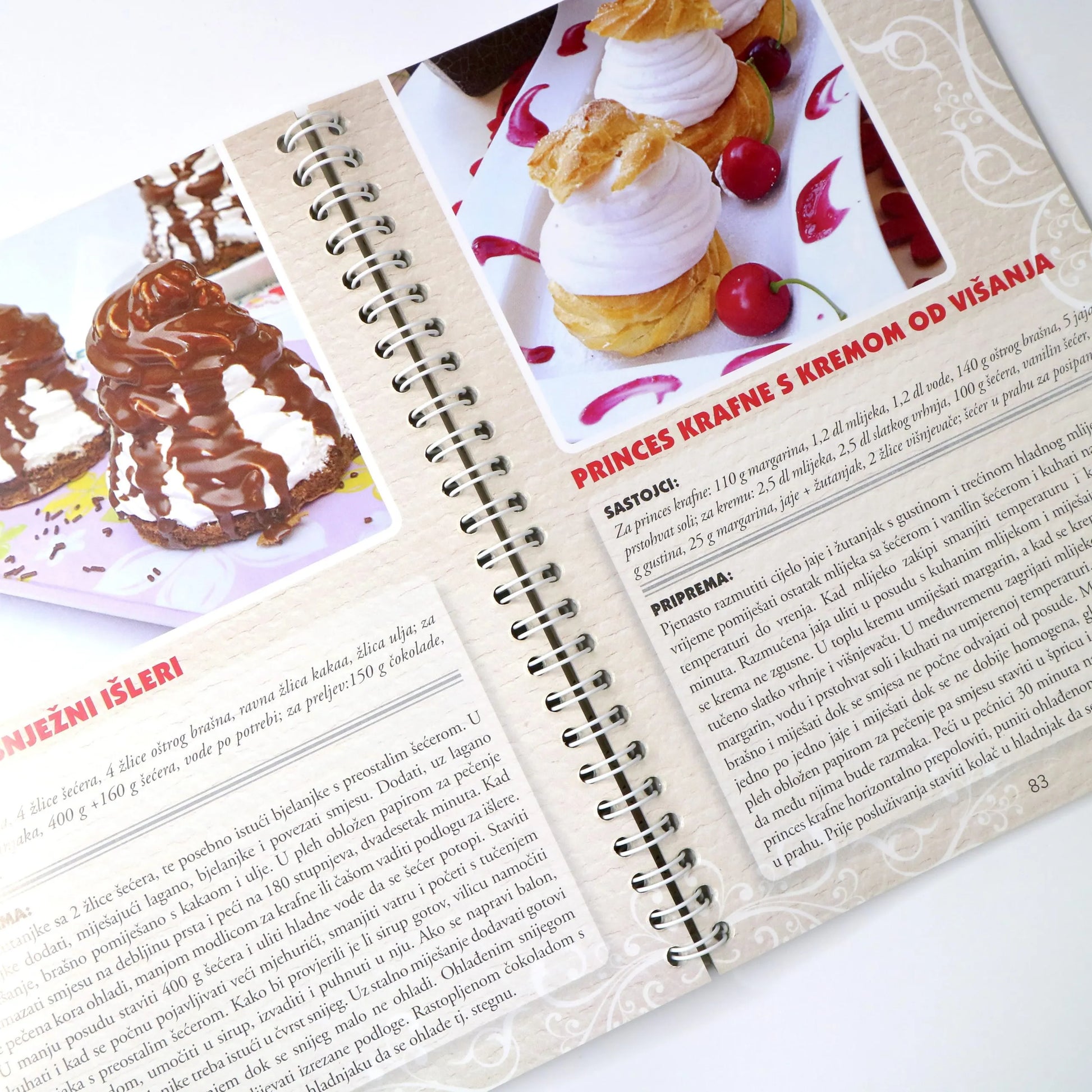 NAJBOLJI DOMAĆI KOLAČI Open cookbook with dessert recipes and images on a white background