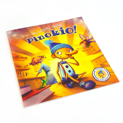Ne kopaj nos, Pinokio! Colorful book cover of 'Pinokio' with animated characters on a white background
