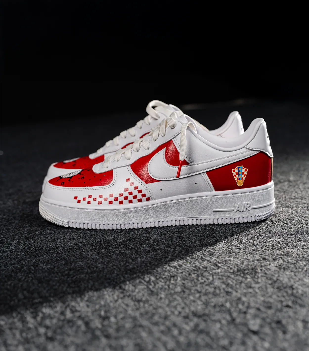 Nike Air Force 1 CROATIA HNS White and red sneaker with a checkered pattern on a dark surface shopncro