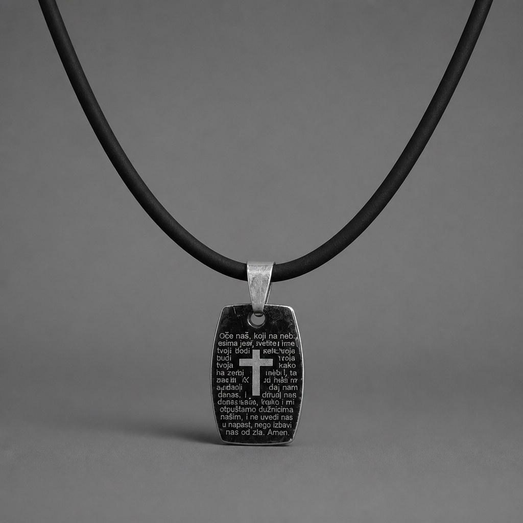 Oče Naš Necklace Black pendant with cross and text on a black cord against a gray background