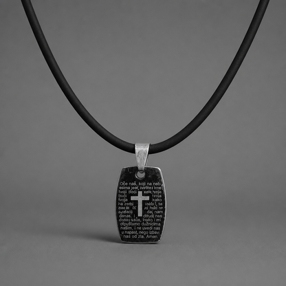Oče Naš Necklace Black pendant with cross and text on a black cord against a gray background