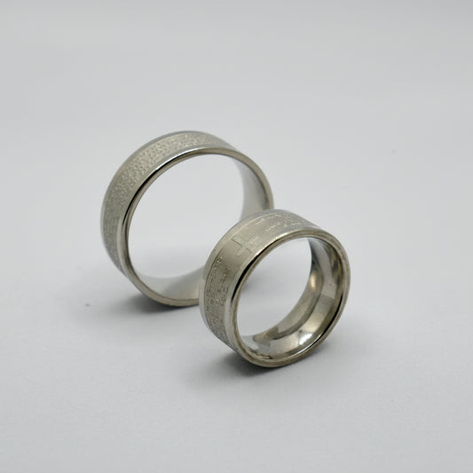 Oče Naš Ring – Silver Finish (17 – 22 Sizes) Two silver rings with size labels on a white background