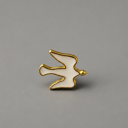 Pin Međugorje - Dove A small bird-shaped enamel pin with a gold outline and white enamel fill, centered on a solid gray background. shopncro