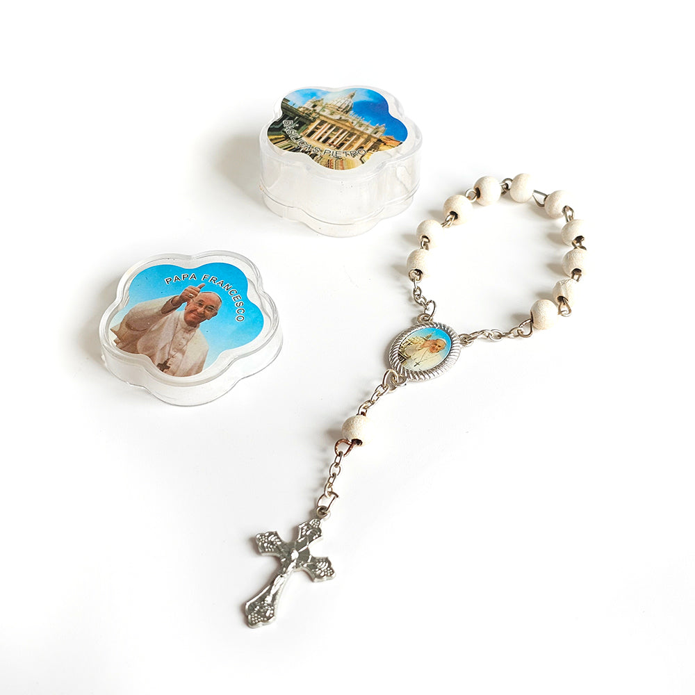 Pope Francis White Catholic Rosary with Vatican Souvenir Case Rosary with religious images on beads and a cross on a white background