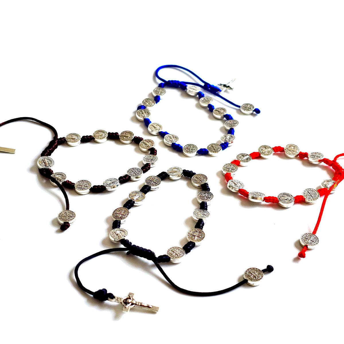 Saint Benedict Adjustable Bracelet with Cross (Black) Set of rosary beads in black, blue, and red on a white background