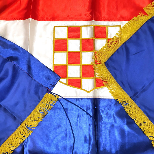 Silk Flag Prvo Bijelo Polje 200x100 Close-up of a flag with red, white, and blue colors and a central emblem.