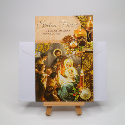 Sretan Božić Golden Christmas Greeting Card Decorative card with religious design on a stand against a white background