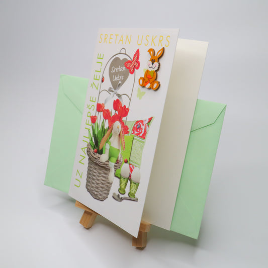 Sretan Uskrs Bunny 3D Easter Greeting Card Easter-themed greeting card with a basket of flowers and a green envelope on a white background