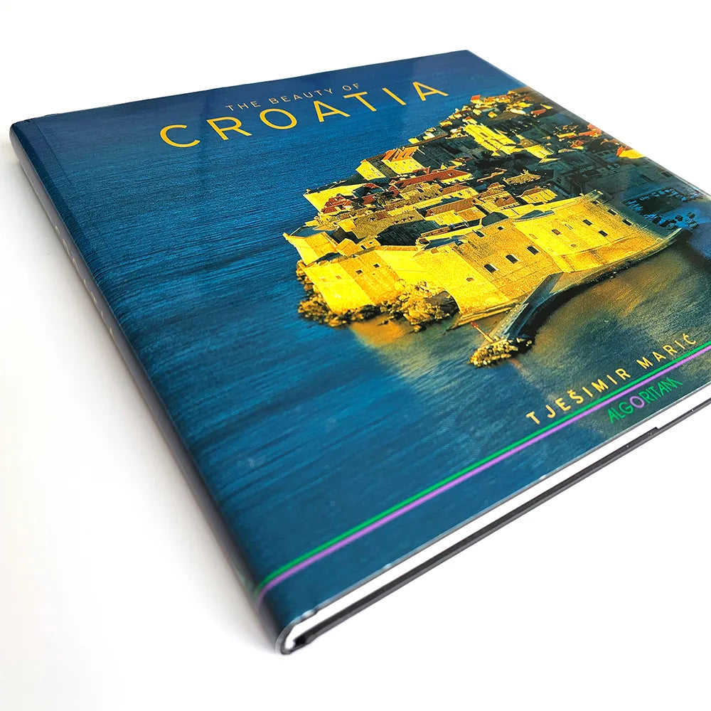 Book titled 'The Beauty of Croatia' with a blue cover and aerial view of a coastal city.