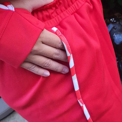 Tracksuit Croatia in Red Close-up of a person wearing a red jacket with a white stripe on the sleeve.