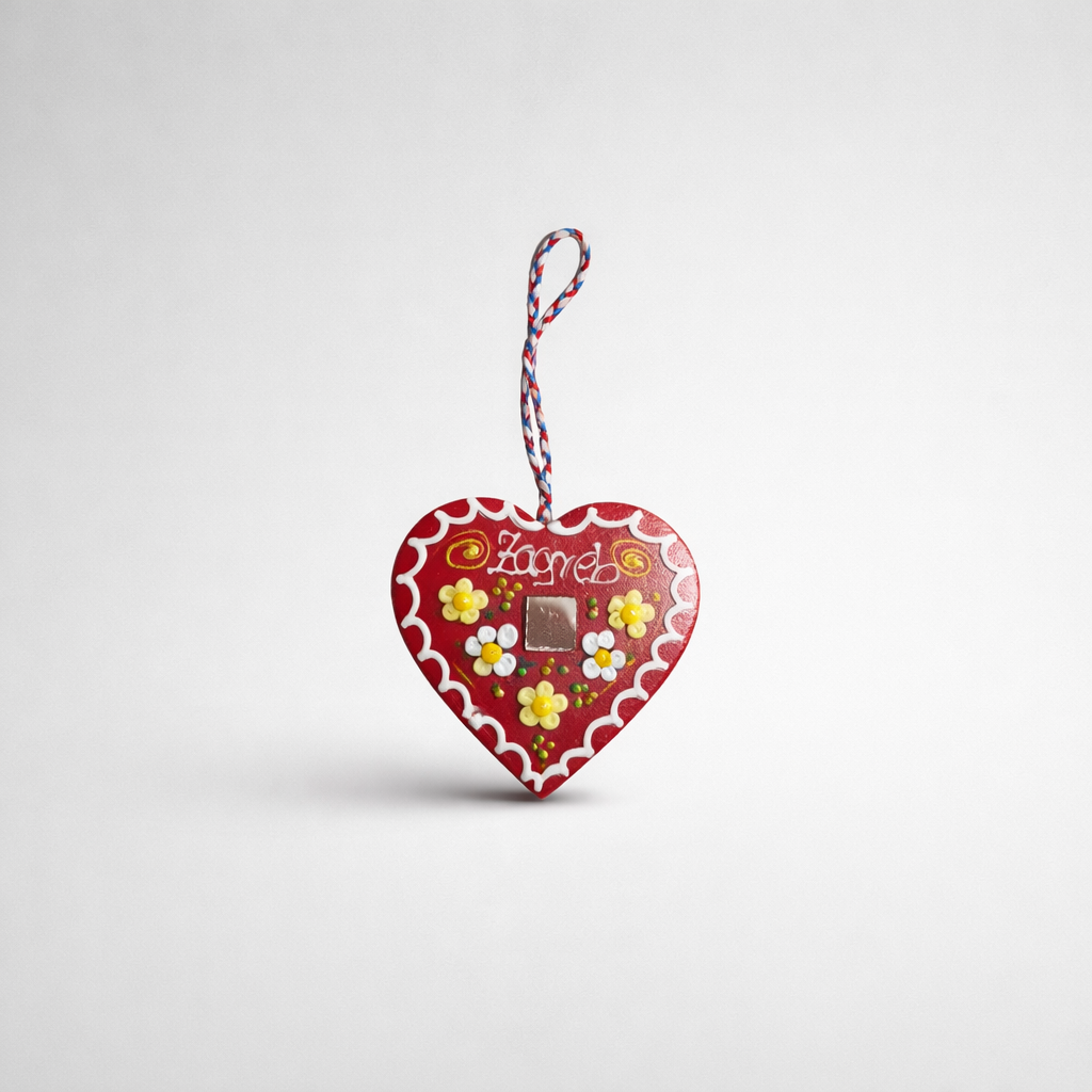 Croatian Traditional Souvenir Licitar (Licitarsko Srce) Heart-shaped chocolate packaging with flowers and 'Lindt' branding on a light gray background