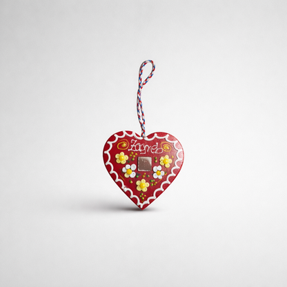 Croatian Traditional Souvenir Licitar (Licitarsko Srce) Heart-shaped chocolate packaging with flowers and 'Lindt' branding on a light gray background