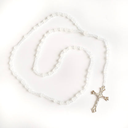 White Bead Catholic Rosary – Silver Crucifix Silver rosary with a cross on a white background