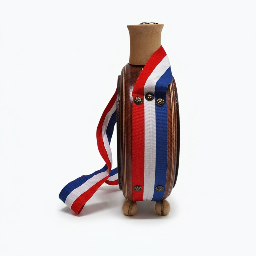 Wooden toy figure with a red, white, and blue ribbon on a white background